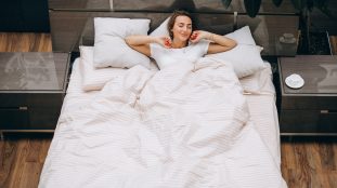 Young woman resting in bed in the morning