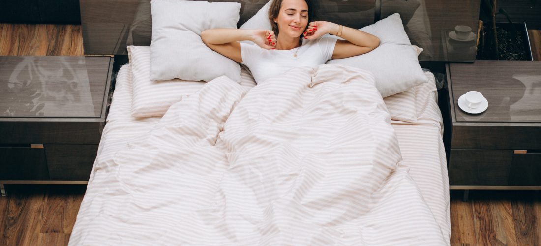 Young woman resting in bed in the morning